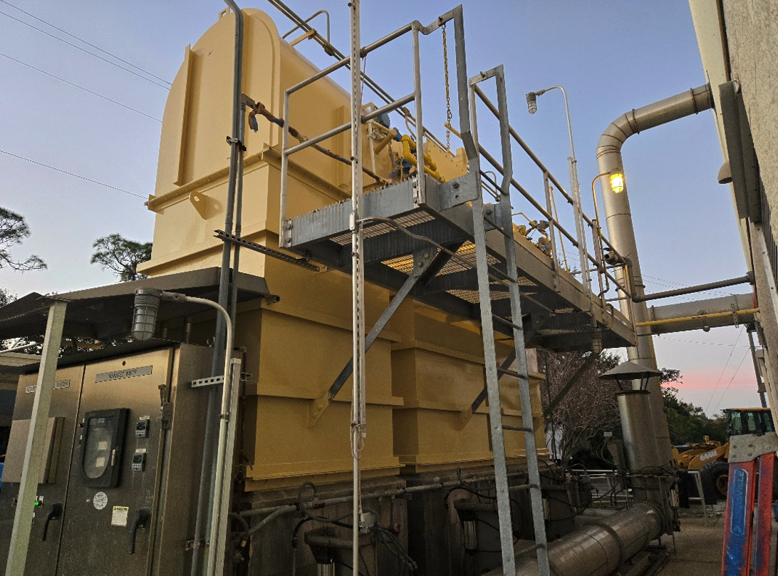 Regenerative thermal oxidizer with elevated gas train, access platform, and burner management control cabinet